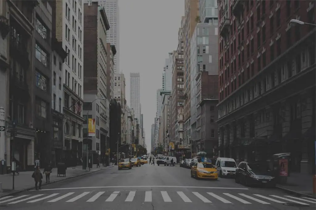 An image of a New York City street with taxi cabs.