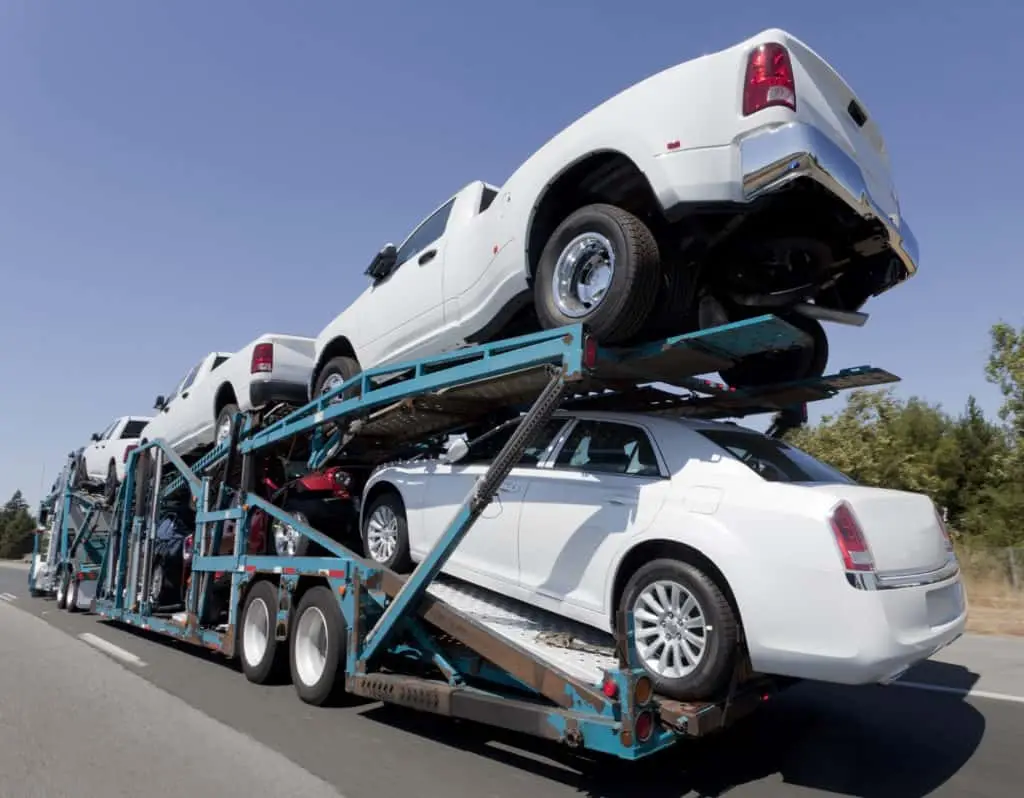 This is an image of a car shipping trailer and truck