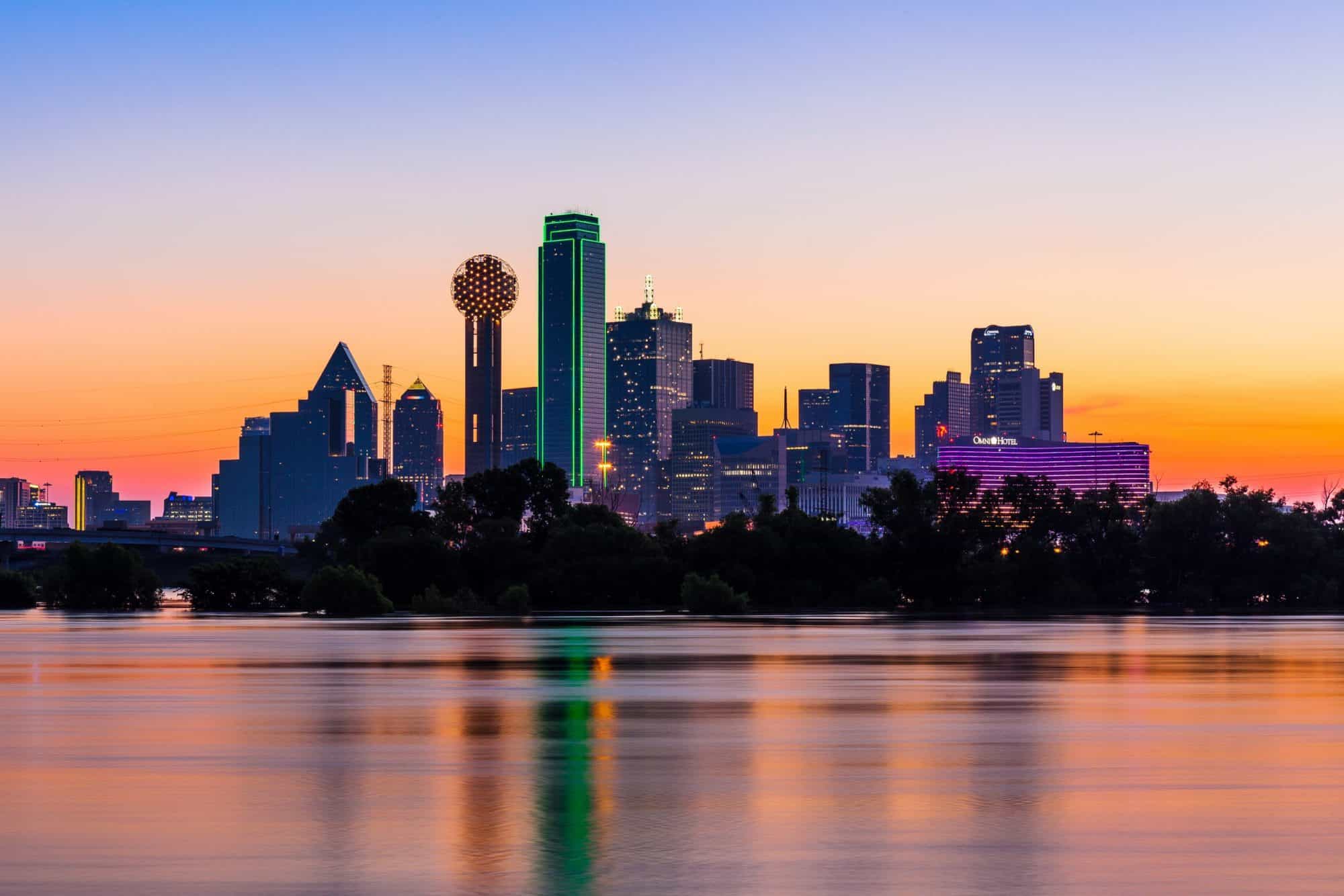 An Image of the Dallas TX Skyline at dusk. Smart Auto Move Car Shipping Dallas