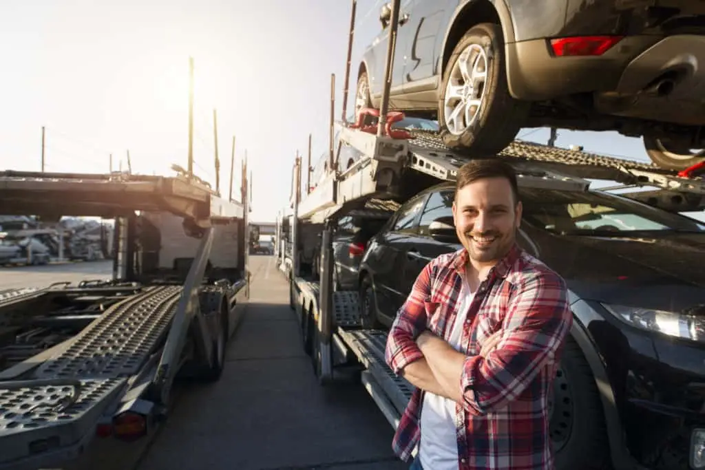 A Car hauling truck driver smiles