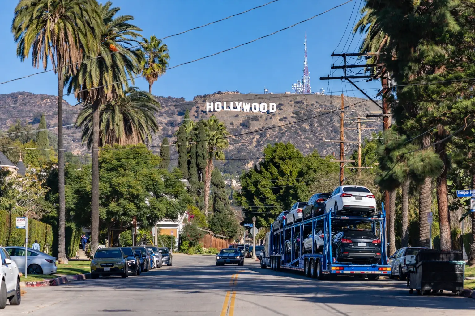 Open car carrier loading a sedan in Los Angeles for delivery from Central Florida